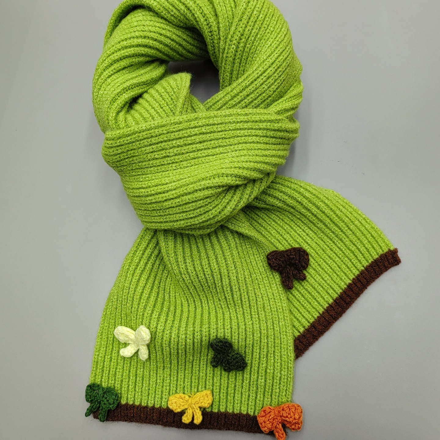 The new handcrafted bow knitted scarf for women in 2024 is a perfect match for winter. It features a contrasting color edge with wool for warmth and a student trend details Picture