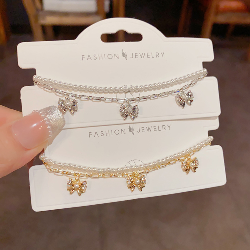 A fresh, fashionable, gentle and versatile double-layer chain pearl bow bracelet, a French light luxury and high-end jewelry accessory