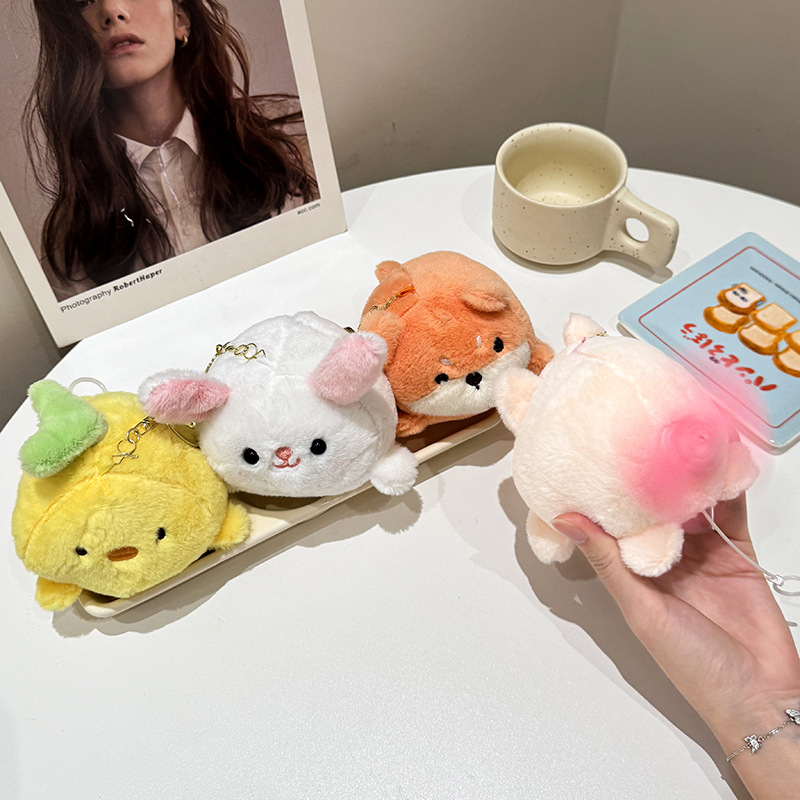 The little cat doll that wags its tail by pulling a rope is called the popular little white rabbit plush toy backpack doll at the street stall details Picture