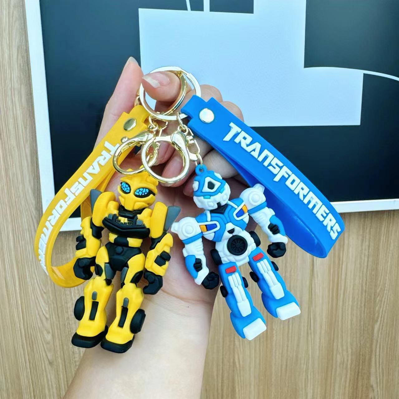 Wholesale of cartoon robot Bumblebee keychains, creative Transformers car pendants, student schoolbags and key chains details Picture