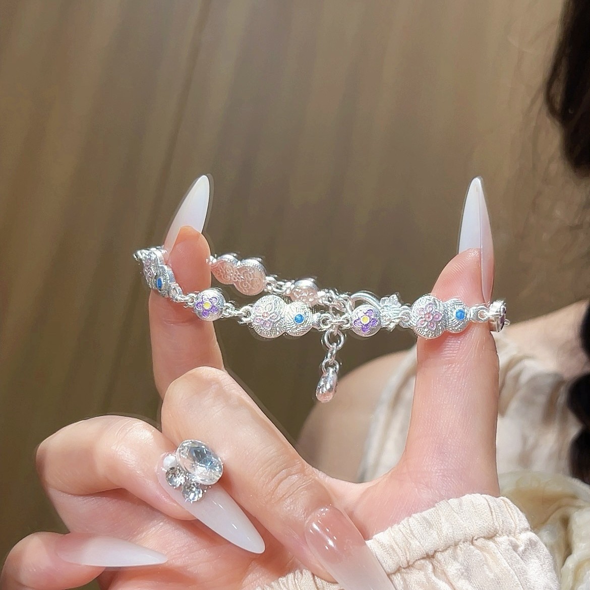 In 2025, a new style of traditional Chinese trend enamel gourd-shaped butterfly clasp hanging lucky bag bracelet with ethnic style and copper plated with Miao silver full figure