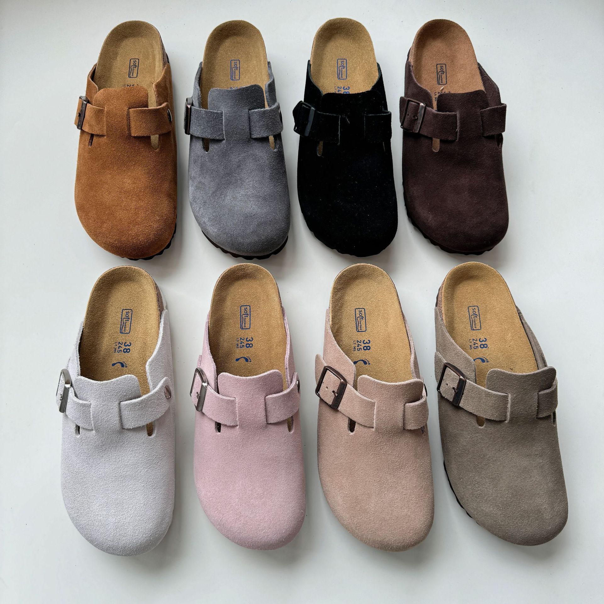 Eight pairs of multi-color suede Burken shoes with metal buckles, size 38, white background