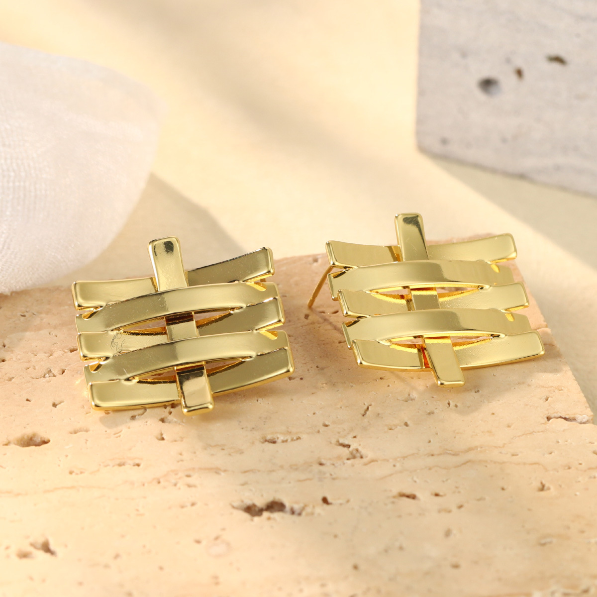 French geometric metal minimalist earrings with an irregular texture, white lava ring and enamel adjustable joints details Picture