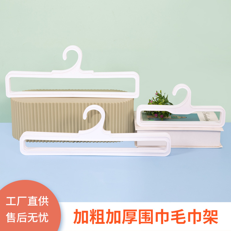 Plastic scarf hangers are displayed in shopping malls and clothing stores. Rectangular racks for scarves and silk scarves are hung in supermarkets for display