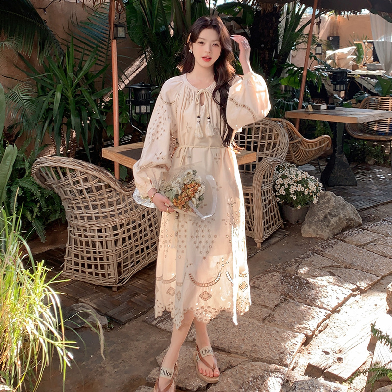 Real photo of a retro, gentle, cut-out embroidered V-neck apricot-colored dress, 2025 new seaside vacation style long-sleeved umbrella dress Application Scenario