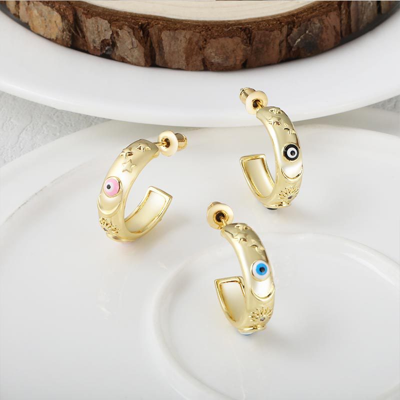 New copper-plated fashionable women's accessories with European and American style, C-shaped niche design stud oil drip Devil's Eye earrings