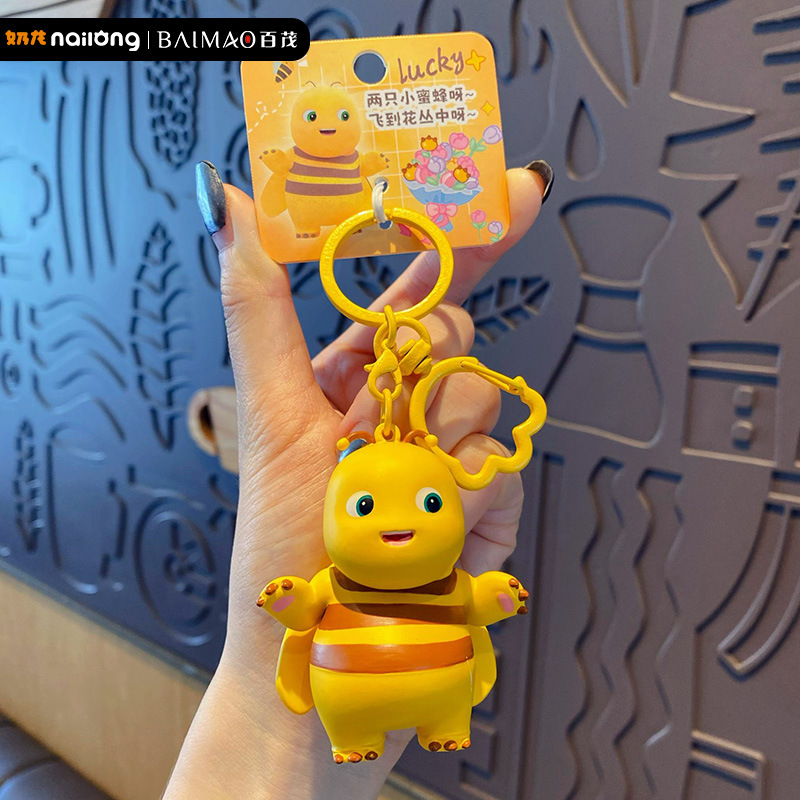 The official Milk Dragon Holiday series keychain is a cute cartoon bee doll keychain for women and a cute schoolbag pendant
