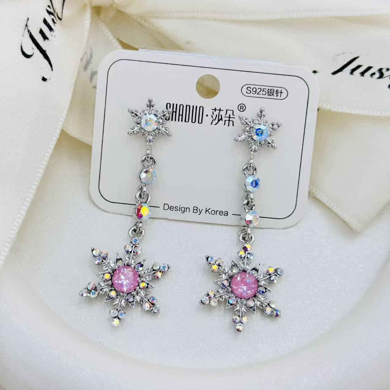 Korean-style silver snowflake-shaped earrings set with rainbow halo crystal S925 silver needle ice crystal background accessory earrings Application Scenario