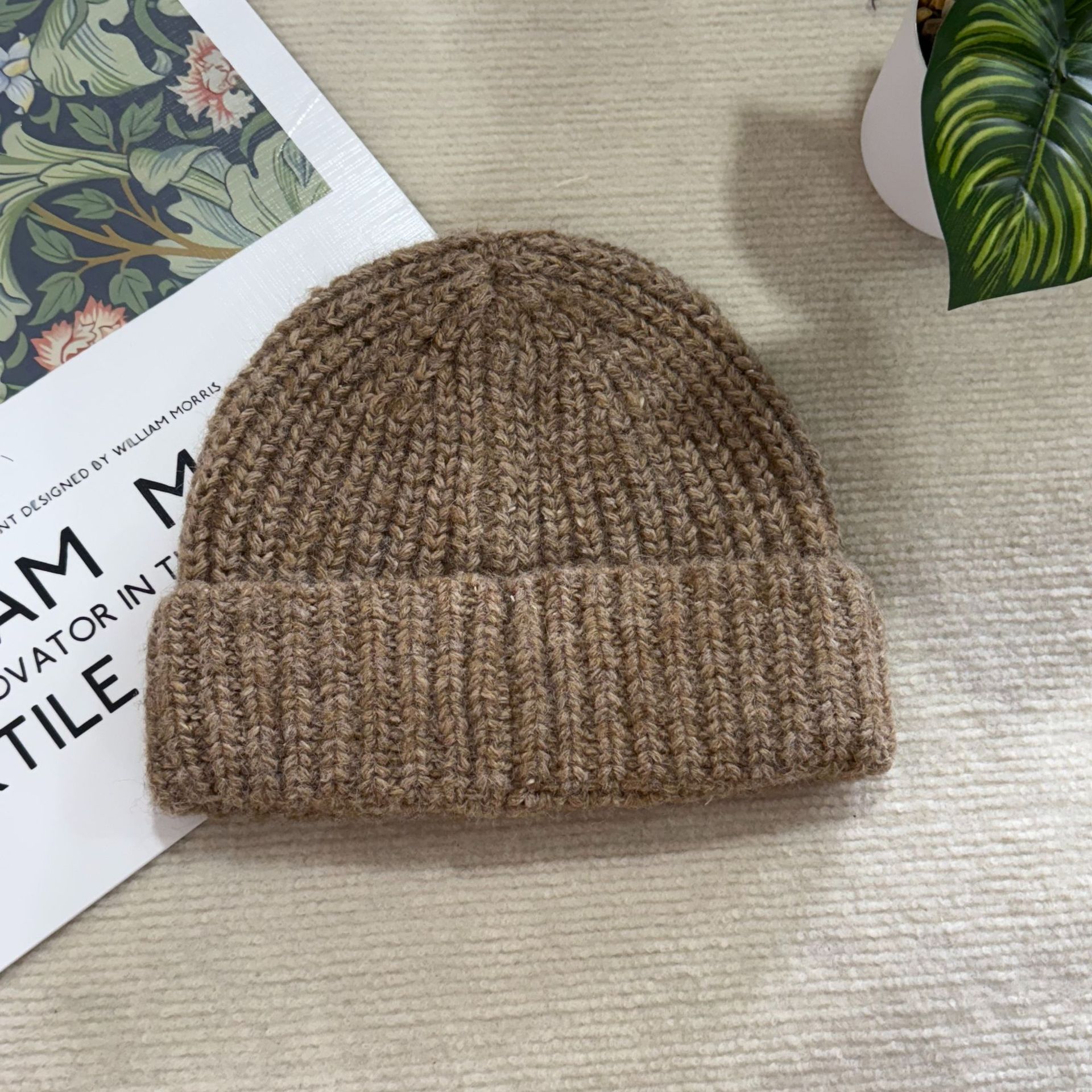 A new style of loose, large-head knitted pile cap for men and women to keep warm in autumn and winter, a woolen cap with ear protection, and a versatile cold hat Application Scenario
