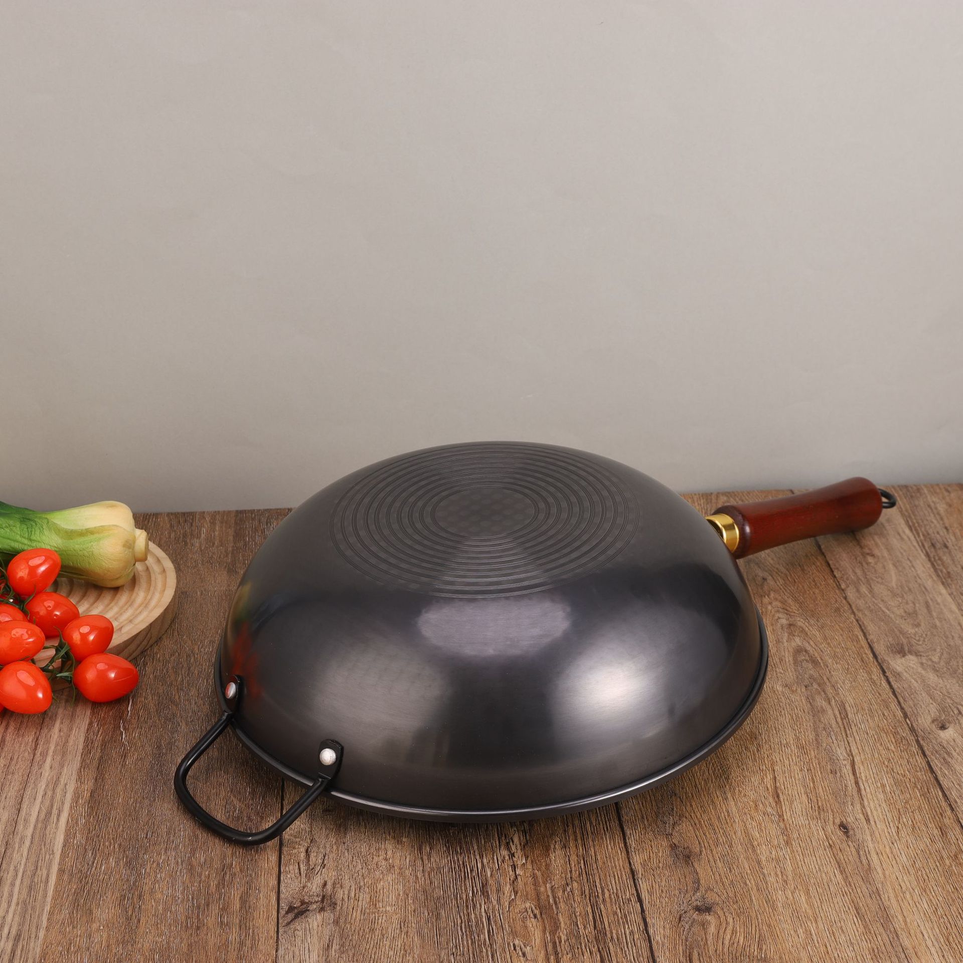 A traditional stir-frying pot with ears, a fine iron wok for kitchen use, an old-fashioned round bottom wok without coating, with a glass lid and non-stick details Picture
