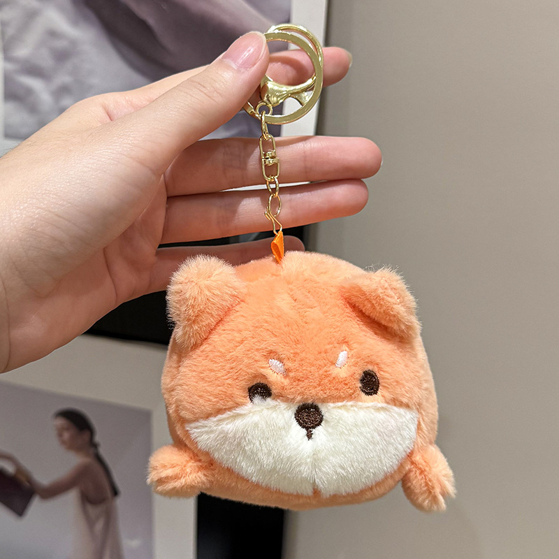 The little cat doll that wags its tail by pulling a rope is called the popular little white rabbit plush toy backpack doll at the street stall Specification image