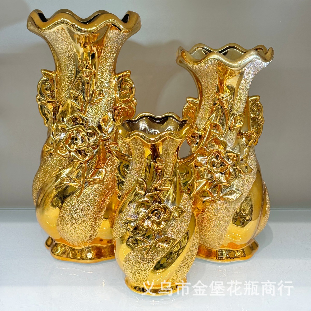 A pair of golden offering vase ceramic vases are placed in front of the 12-inch ceramic gilded Guanyin Nectar Vase Buddha