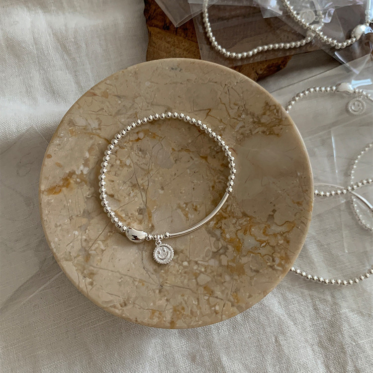 S925 sterling silver smiley face bean elastic beaded bracelet: simple and versatile, light luxury, ins niche jewelry with a sense of sophistication Application Scenario