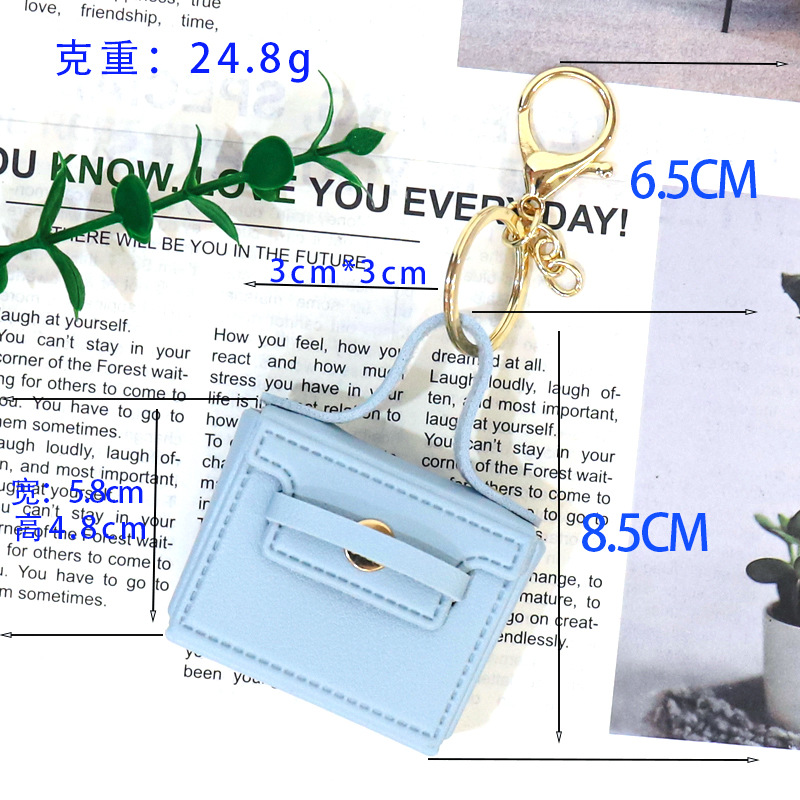 Huayang's new multi-functional small square bag features a creative mouth, red envelope, keychain, earphone bag, and a car-carrying pu key chain pendant Application Scenario
