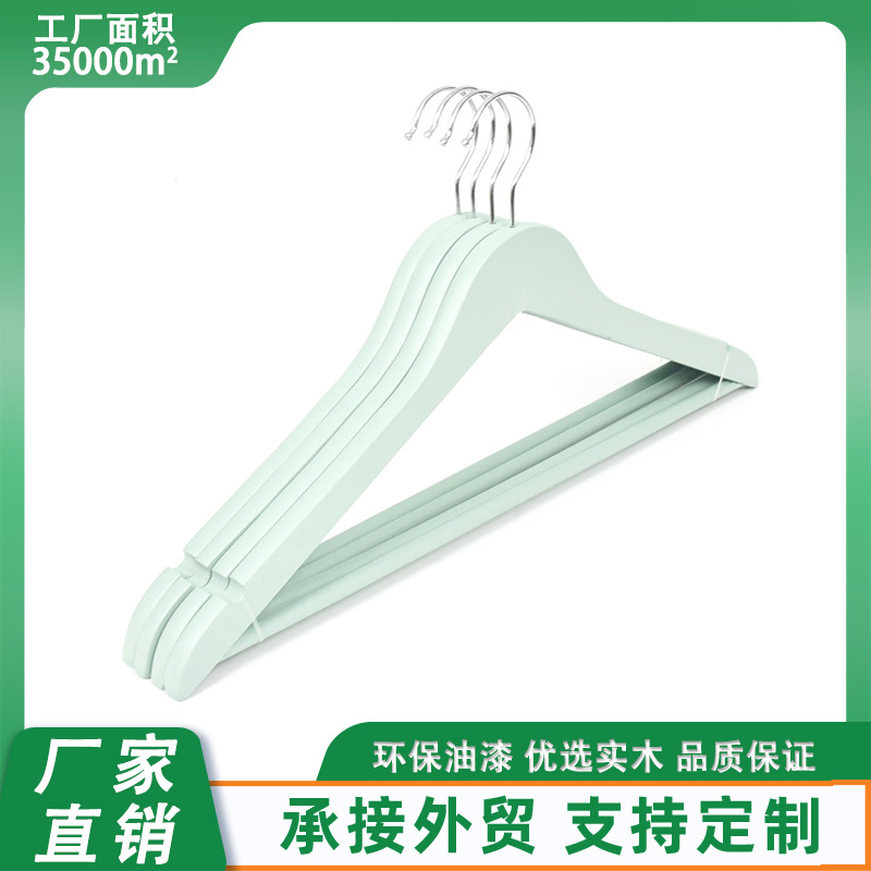 Wholesale of solid wood clothes hangers for clothing stores, fresh green, anti-slip wooden clothes supports for women's clothing, and solid wood clothes hangers and trouser clips for adults