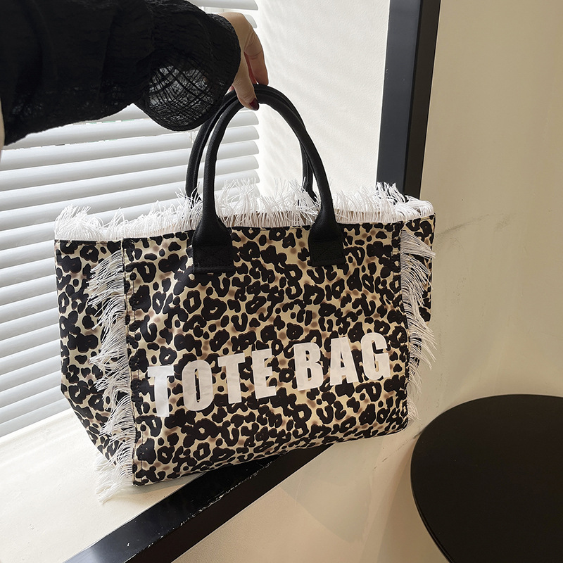 Cross-border canvas bag, denim print canvas bag, zebra print fringed letter canvas bag, large capacity bag, women's bag, new solid color commuting single-shoulder tote bag, beach bag, fringed canvas bag, tote bag, single-shoulder bag, canvas bag