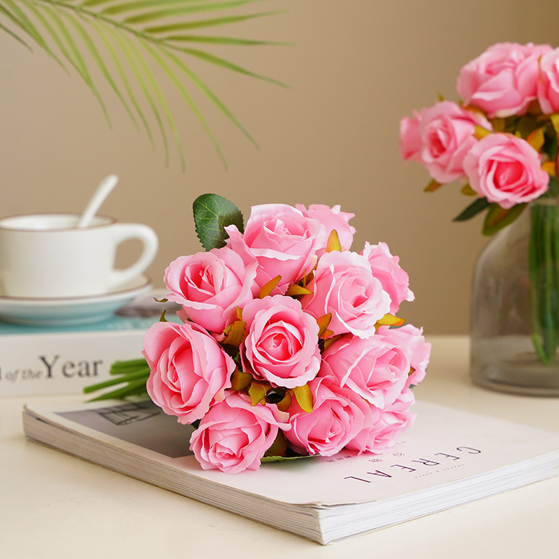 A Korean-style wedding bride is holding a bouquet of 12 small roses for home decoration. The artificial flowers are a simulation of 12 small roses details Picture
