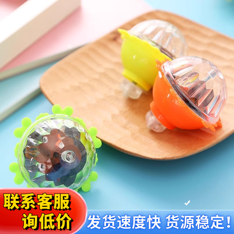 Wholesale of popular toys at street stalls: colorful glowing lace gyroscopes, flashing gyroscopes, and glowing toys