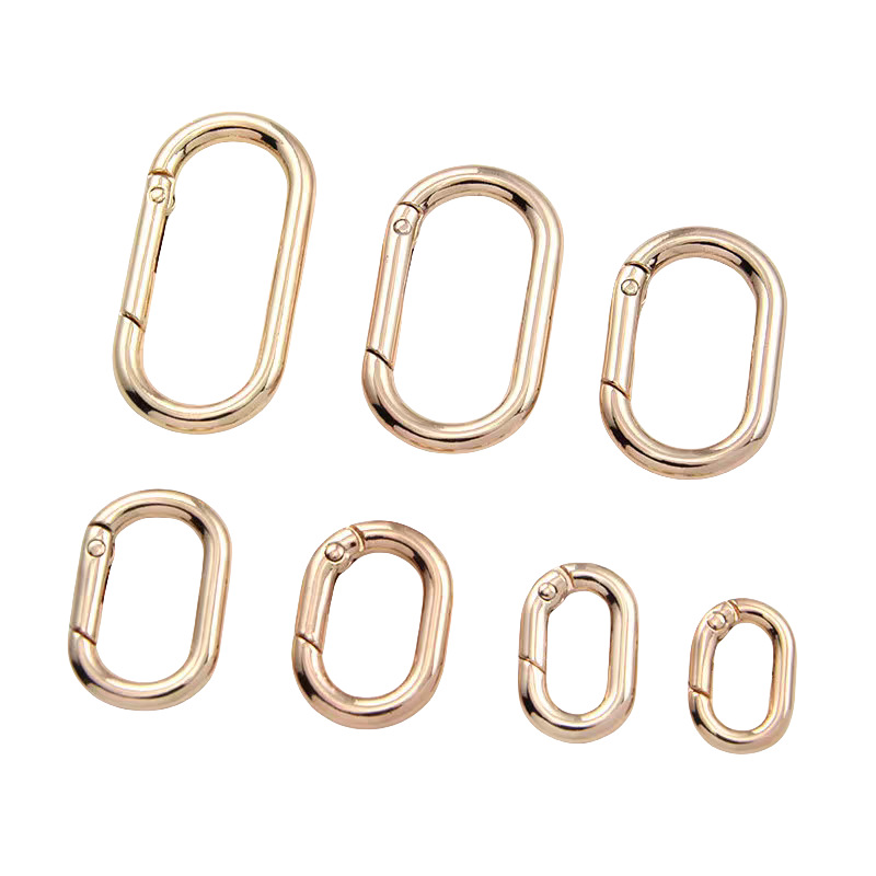 Light gold pressable spring ring, electroplated alloy elliptical denel-shaped ring, open ring, bag hardware accessories, spring buckle Item Picture