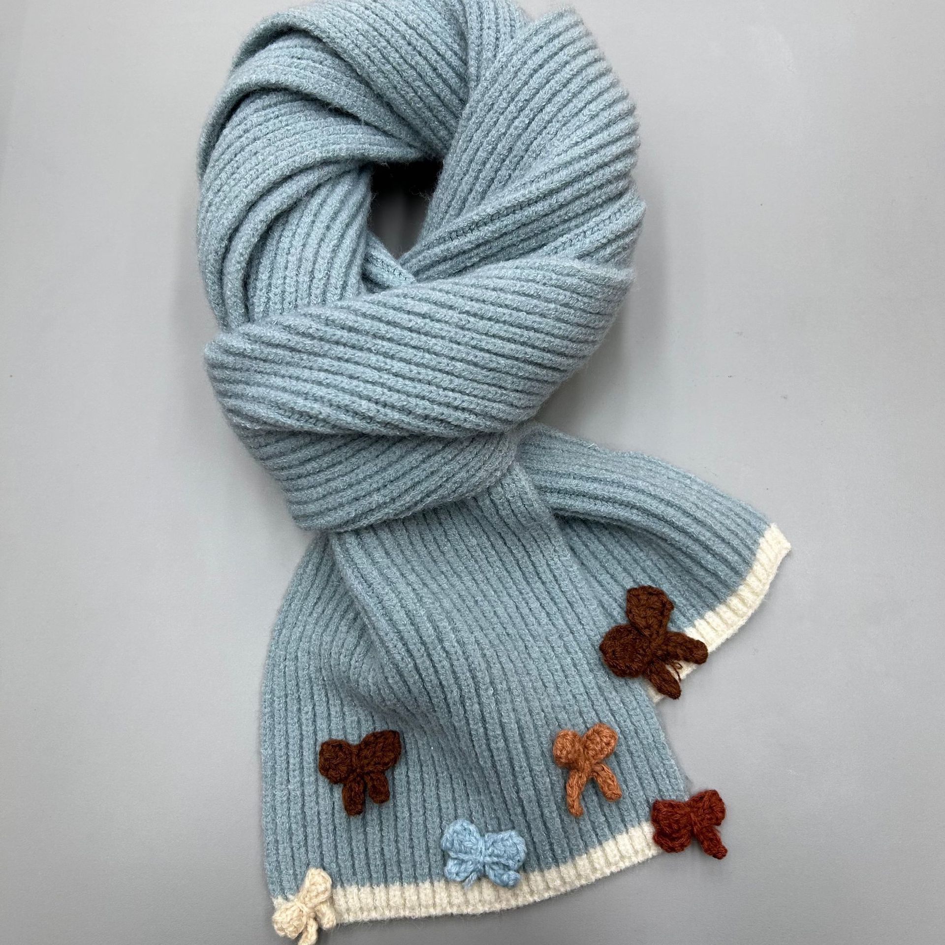 The new handcrafted bow knitted scarf for women in 2024 is a perfect match for winter. It features a contrasting color edge with wool for warmth and a student trend Application Scenario