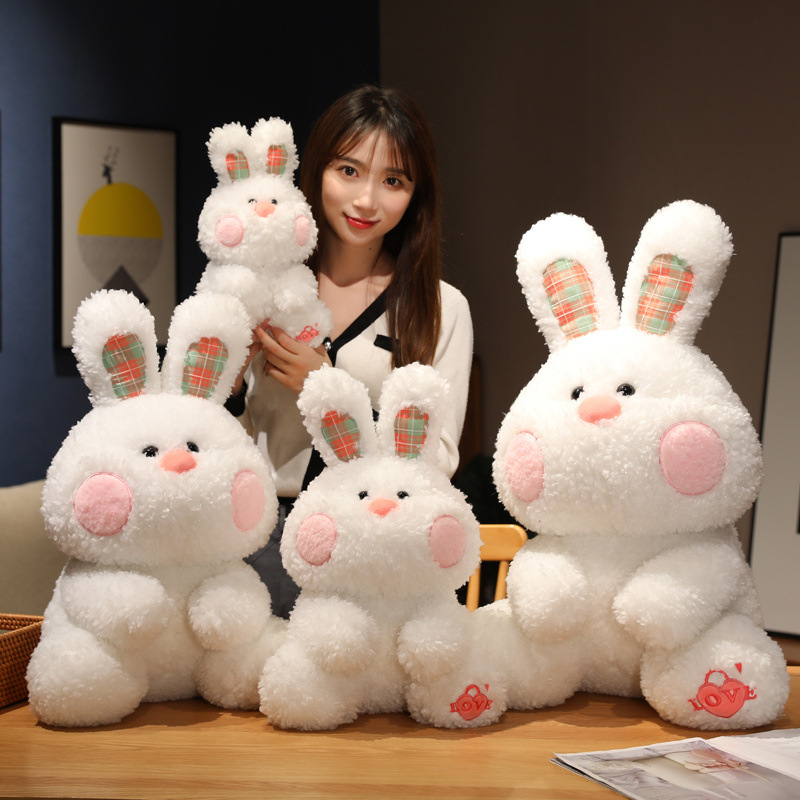 Super soft and cute checkered rabbit plush toy doll, adorable little white rabbit long throw pillow, girl holding rabbit doll on the bed