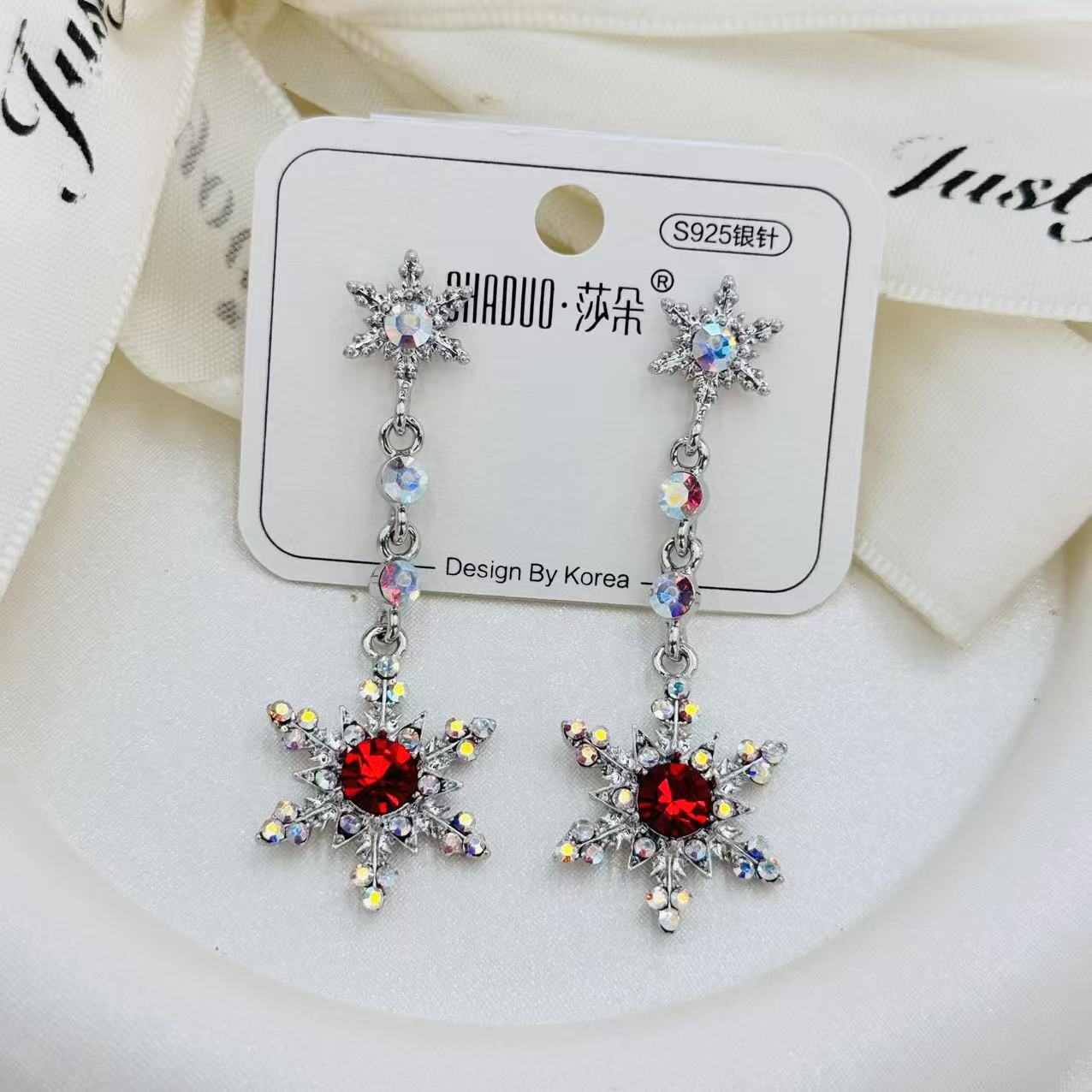 Korean-style silver snowflake-shaped earrings set with rainbow halo crystal S925 silver needle ice crystal background accessory earrings details Picture
