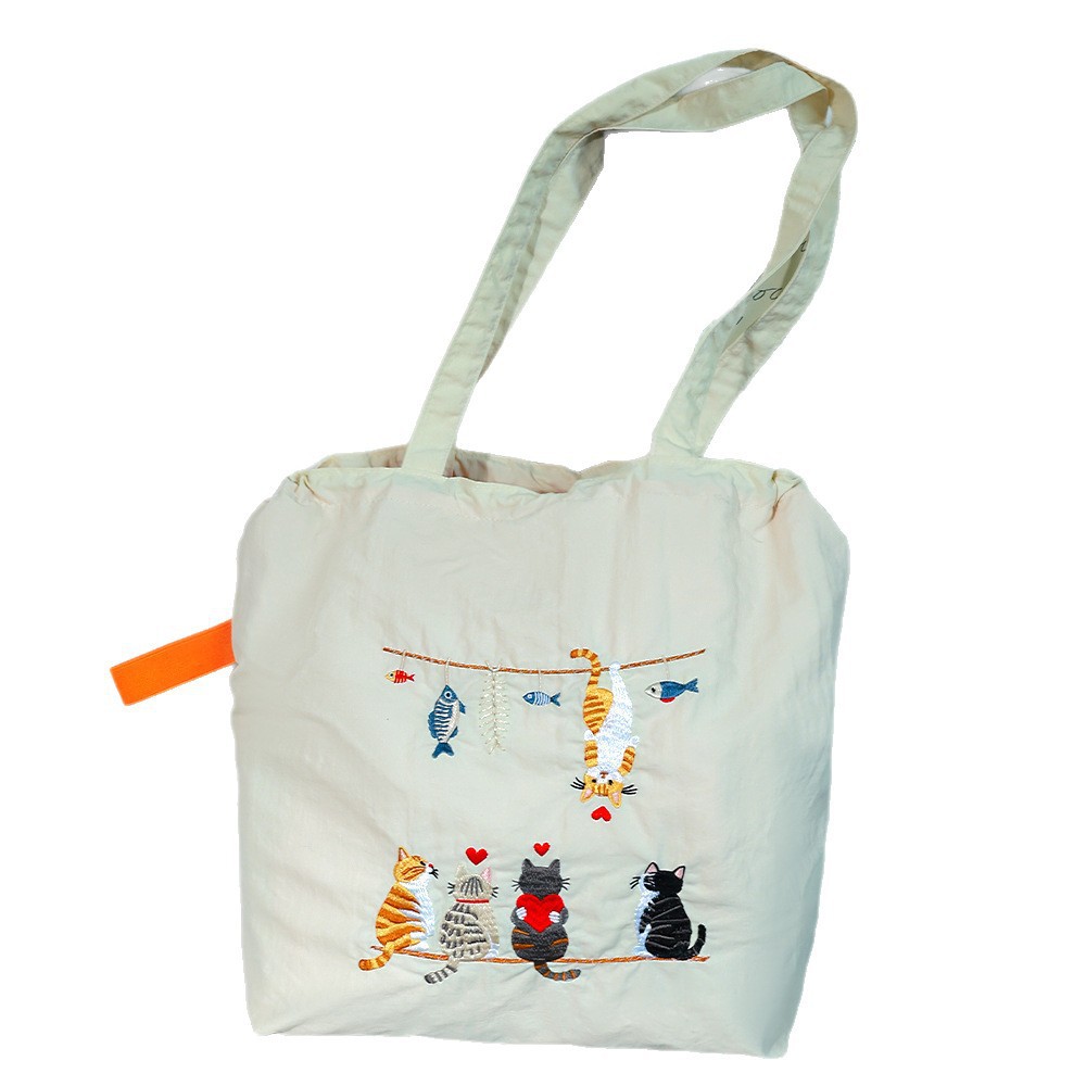 韩版新款百搭日系束口刺绣手提袋日常通勤清新学生大容量托特包女白底实物图