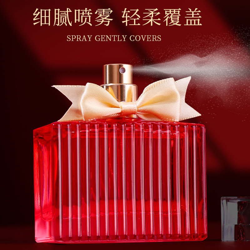 A sample of 88ml domestic body fragrance spray perfume with a red striped glass perfume bottle and a golden nozzle bow