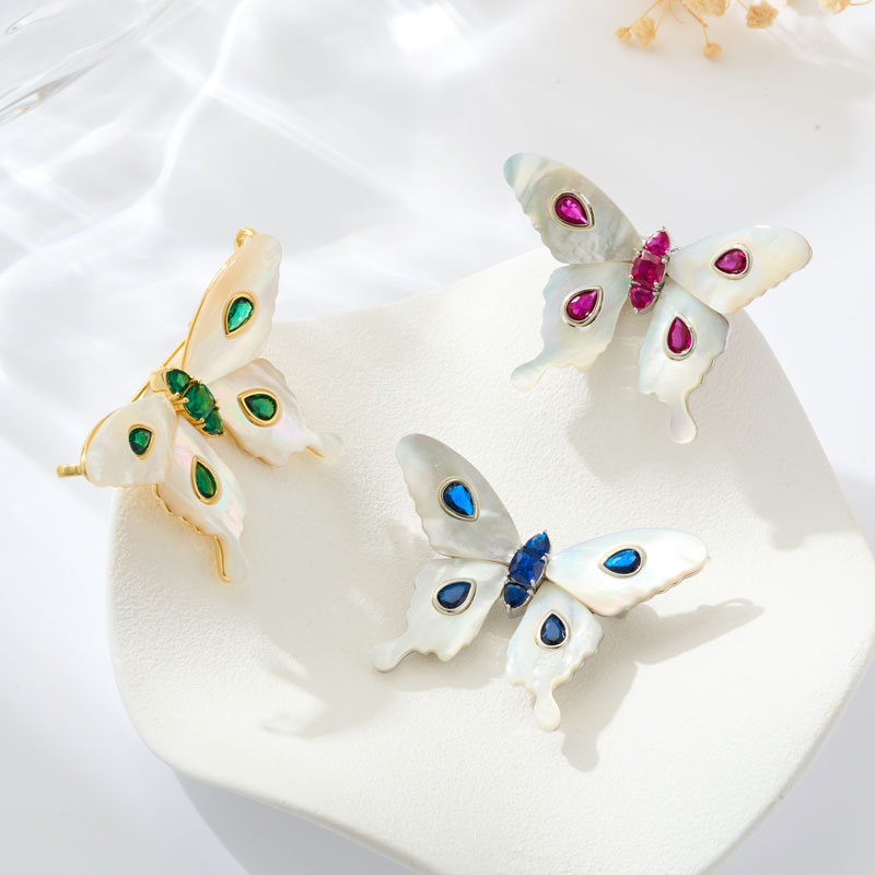 A light luxury and high-end natural mother-of-pearl butterfly brooch, an original design of copper alloy with zirconium emerald blue spinel