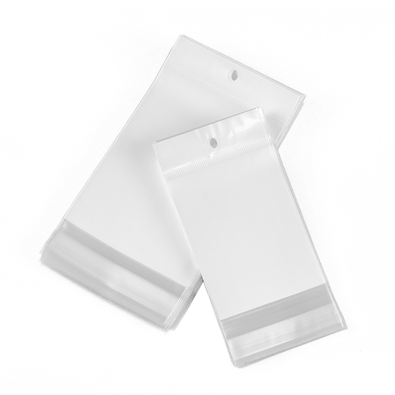 现货透明不干胶内膜卡头自粘袋opp珠光袋饰品塑料包装封口挂孔袋白底实物图