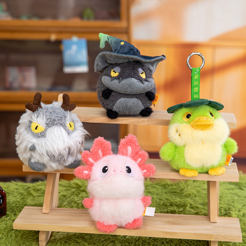 A grey totoro wearing a wizard hat and a red horned dragon plush toy AI star Man AI toy details Picture