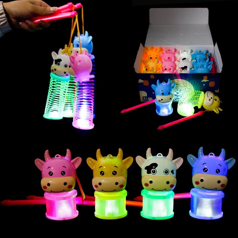 Cartoon rainbow circle spring hand-held lanterns and hand-held glowing bull lanterns are selling well at street stalls as toys for the Year of the Ox Application Scenario