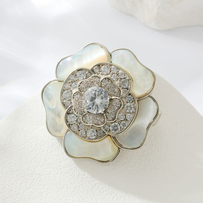 A light luxury and high-end natural mother-of-pearl camellia brooch, copper alloy slightly inlaid zircon, fashionable and versatile women's accessory pin Application Scenario