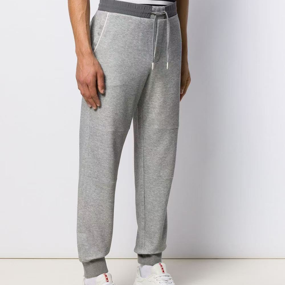 The European station's autumn collection features a new trend of simple and fashionable embroidered color-blocking, tight-waisted, drawstring, and tight-fitting men's business casual pants
