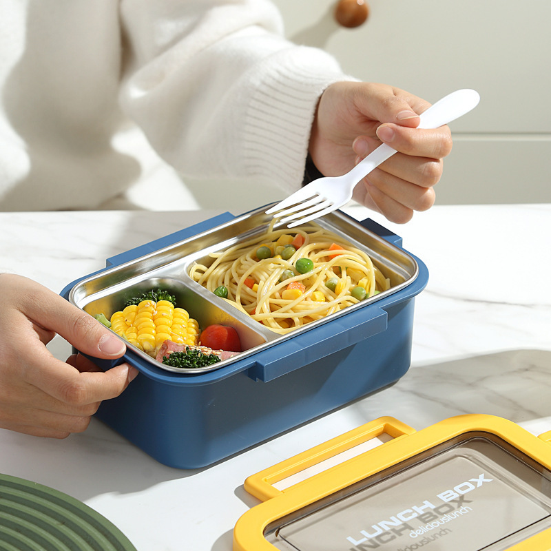 The simple and sealed double-layer lunch box with compartments is portable for office workers and students. It is a stainless steel box with heat preservation details Picture