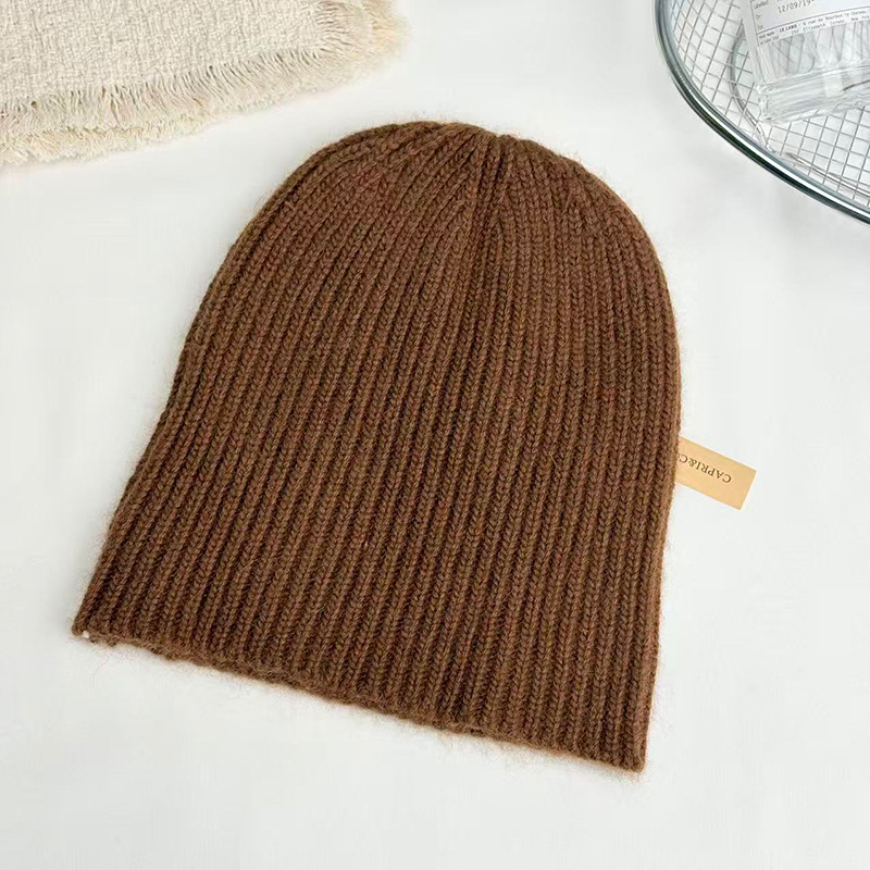 Raccoon wool European and American fashionable warm hat, knitted woolen women's ear cap, winter women's face-showing small bun, trendy solid color Specification image