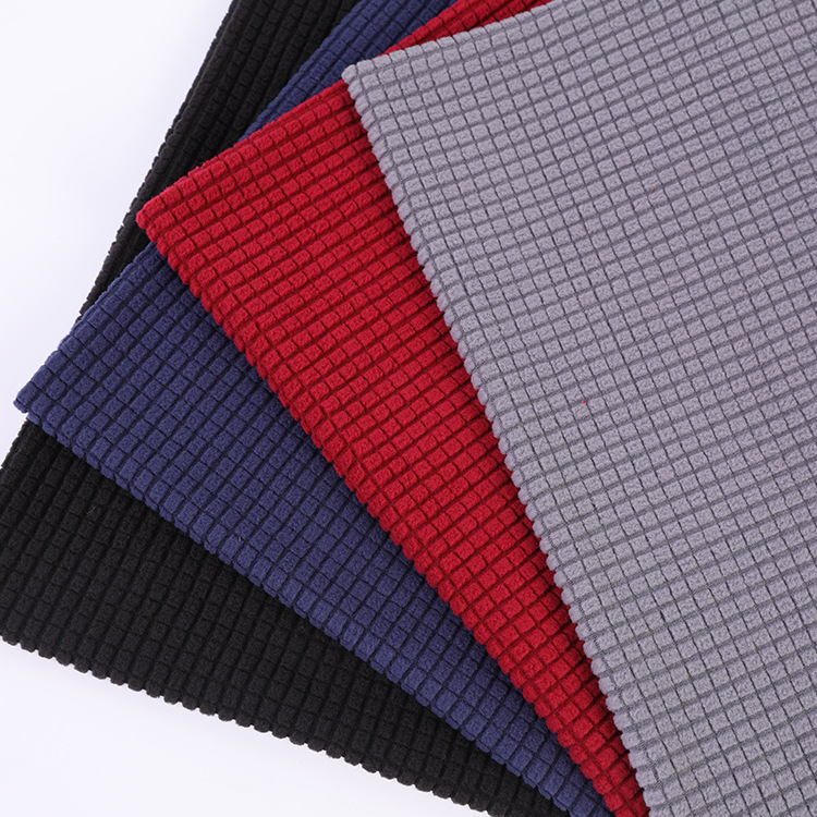 The manufacturer has in stock knitted diamond-shaped large and small checkered jacquard air layer fabric, polyester and ammonia tr clothing and home textile dyed fabric