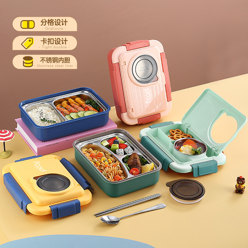 A popular stainless steel three-compartment lunch box with spoons, chopsticks and a small bowl, sealed and compartments, for office workers in the cafeteria