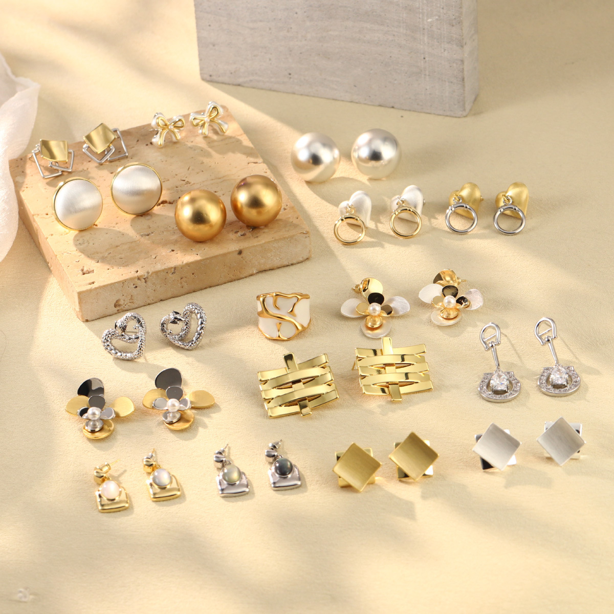 French geometric metal minimalist earrings with an irregular texture, white lava ring and enamel adjustable joints