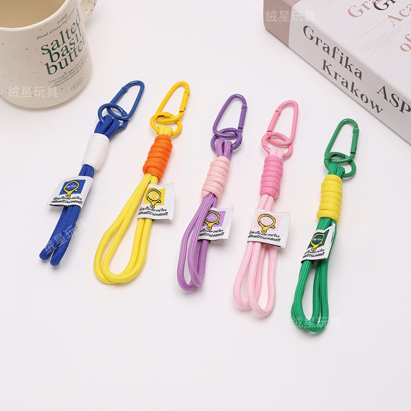 Creative figurine pendant accessories, couple mobile phone lanyards, keychains, hand-woven color-blocked hand lanyards, water cup bag pendants details Picture