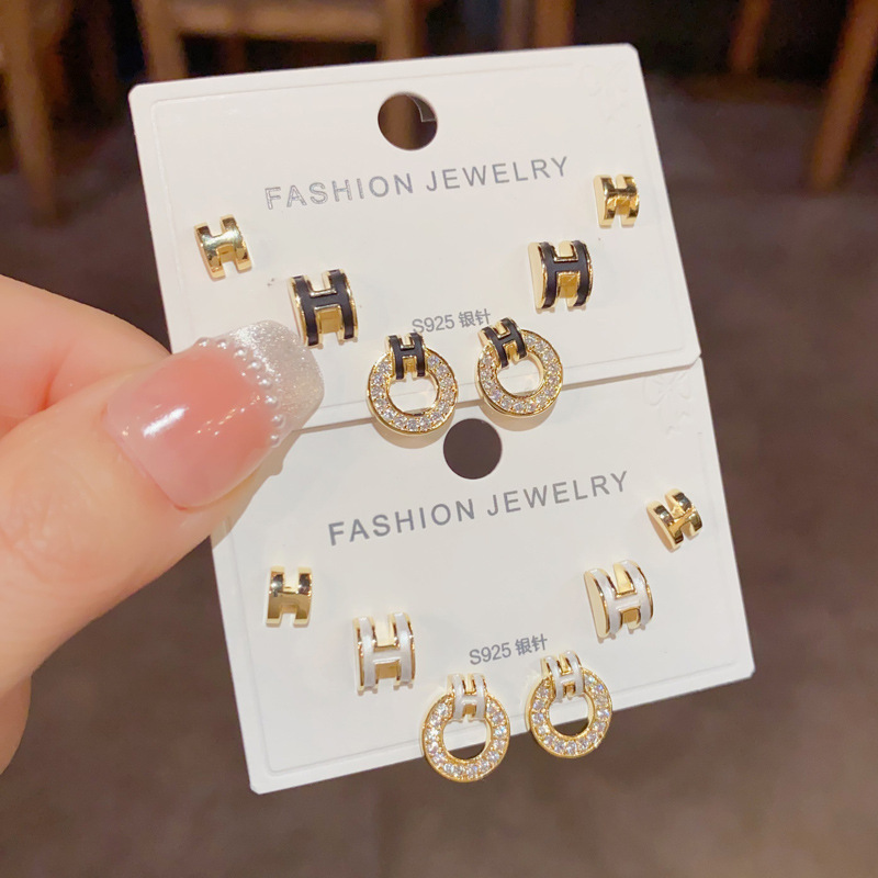 Wholesale of small and fashionable H-letter circular three-piece ear stud earrings with a feminine charm, simple and compact silver needle earrings