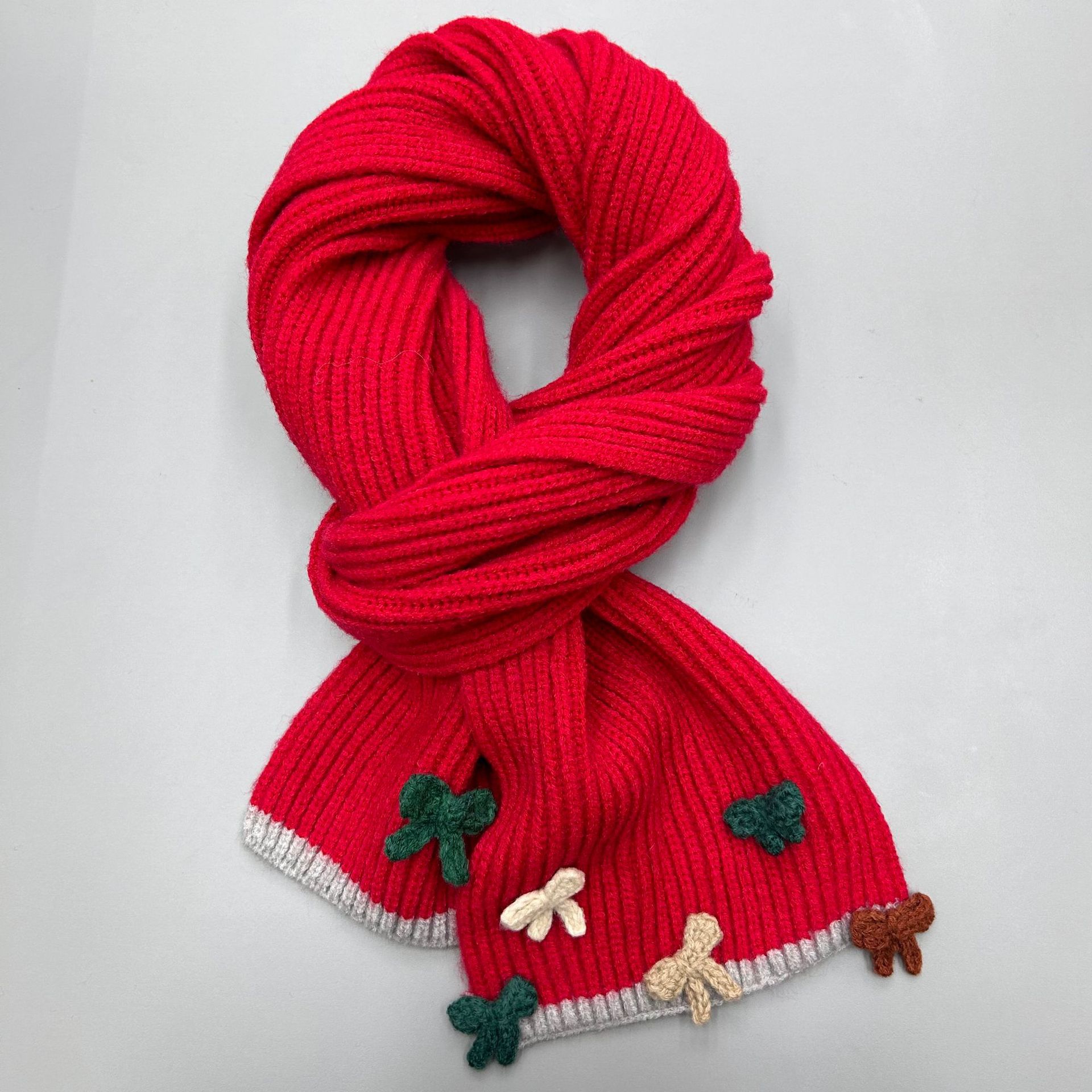The new handcrafted bow knitted scarf for women in 2024 is a perfect match for winter. It features a contrasting color edge with wool for warmth and a student trend