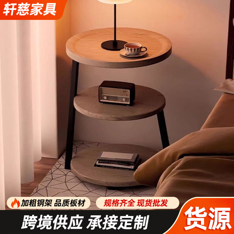The bedside table is a small, vintage, creative round table for home use. It is a three-story bedroom bedside storage rack with a unique design sense