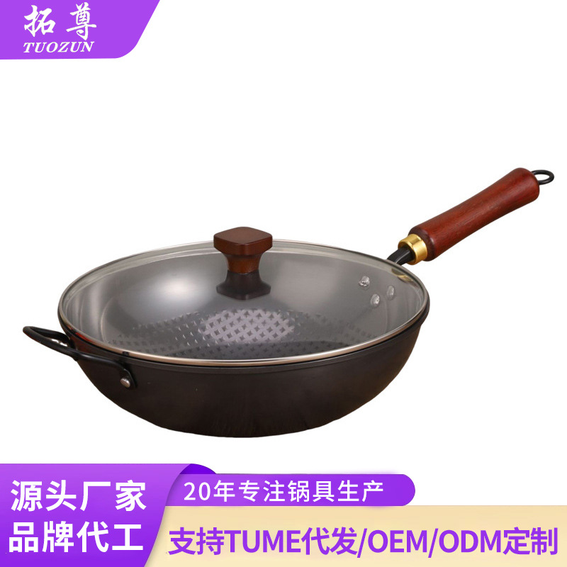 A traditional stir-frying pot with ears, a fine iron wok for kitchen use, an old-fashioned round bottom wok without coating, with a glass lid and non-stick