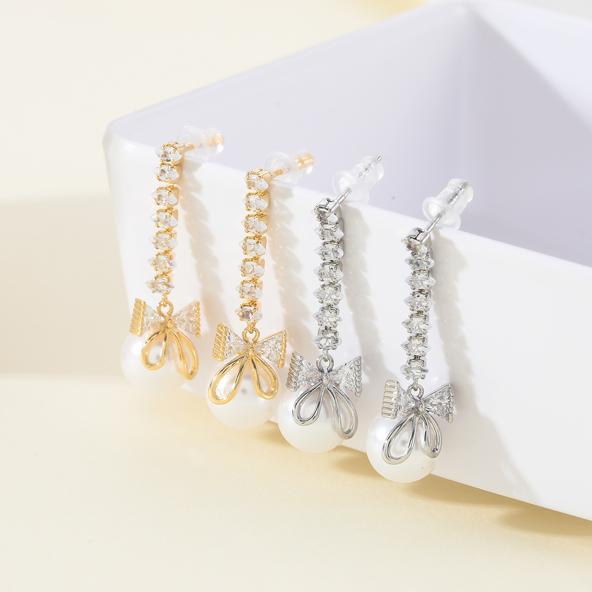 Gentle and lustrous pearl earrings, women's InS-style niche design sense S925 silver needle zircon bow earrings wholesale full figure