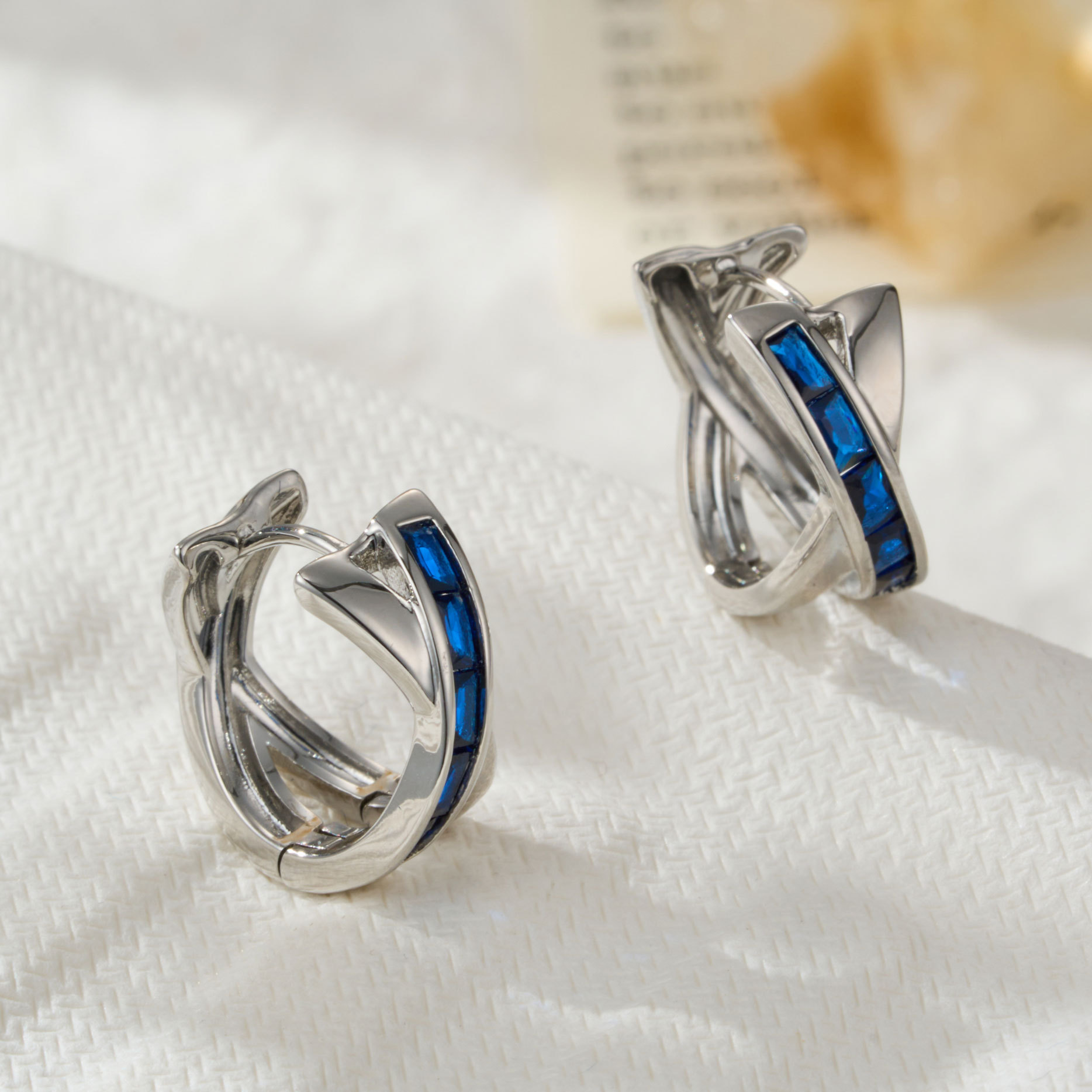 The light luxury and high-end blue square zirconium cross-shaped earrings, a niche minimalist style ear buckle, is a new versatile earpiece for commuting