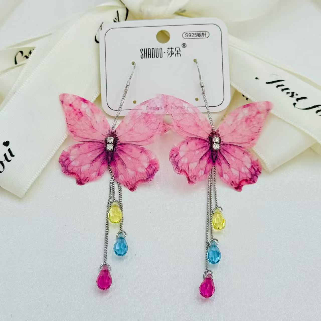S925 plata aguja mariposa pendientes mujeres largo borla pendientes austria cristal orejas versión coreana de moda temperamento pendientes
