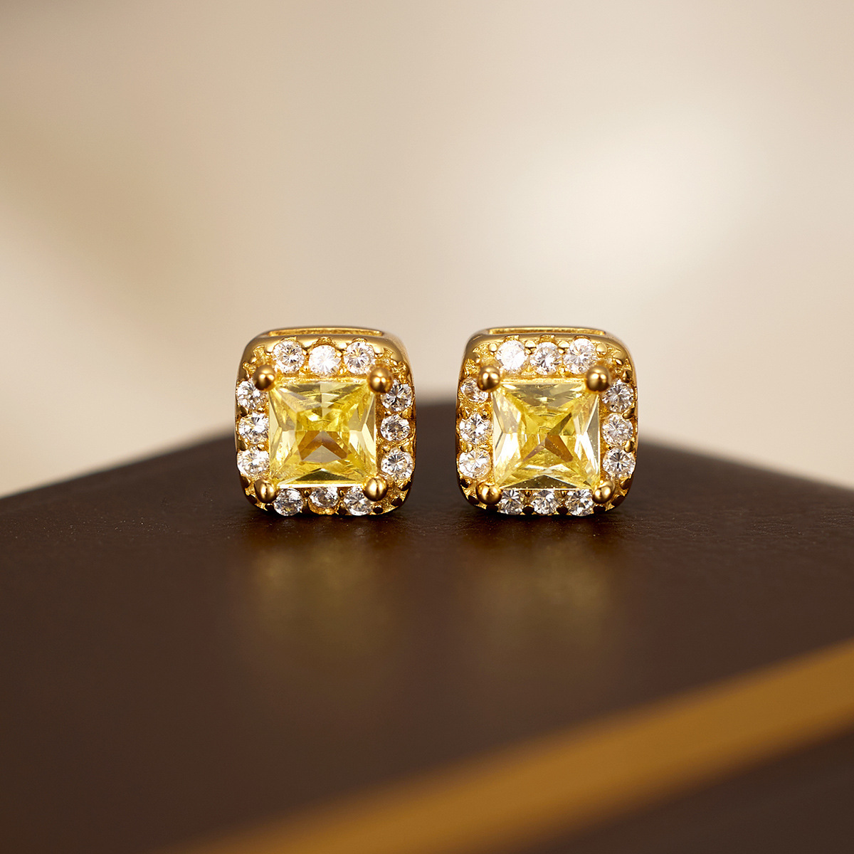 The new light luxury small square sugar stud earrings for women are fashionable and simple. The small square yellow diamond electroplated 18K silver earrings are selling well in Europe and America