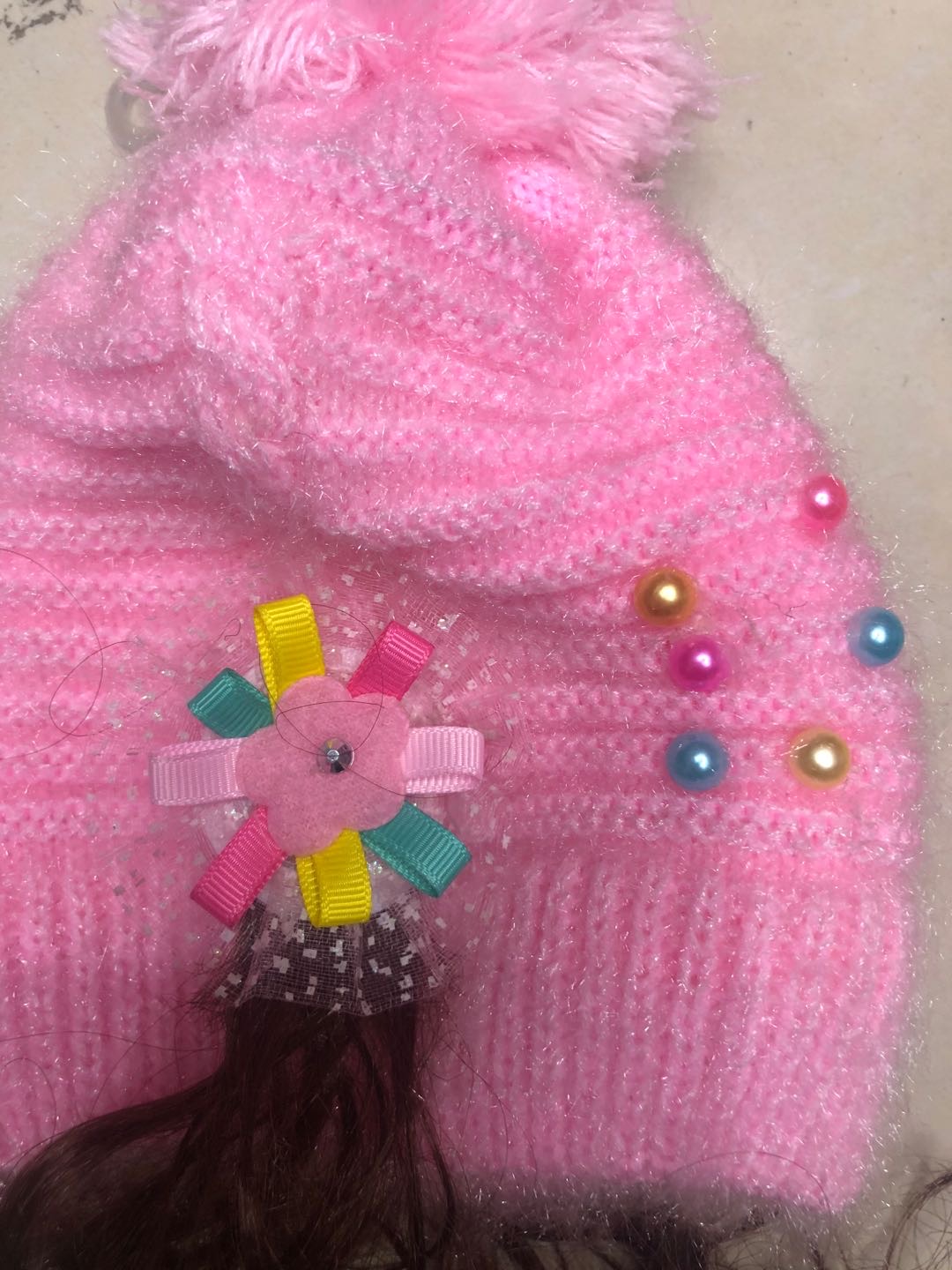 Baby girl wearing knitted princess hat in outdoor park setting
