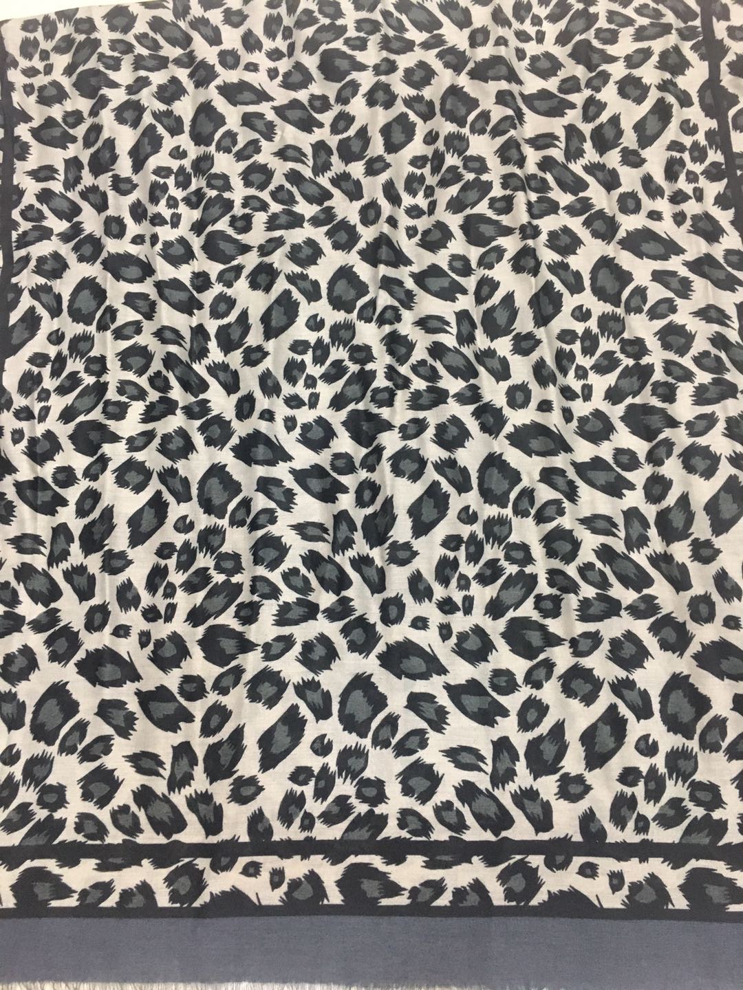 A trendy and popular women's scarf with a thin satin polka dot leopard print details Picture